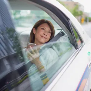 Young woman booking a local taxi service in Hubli for a comfortable city ride.